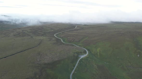 A Narrow Curvy Road In The Lush Wicklow Mountains In Ireland On A Wonderful Morning - aerial drone