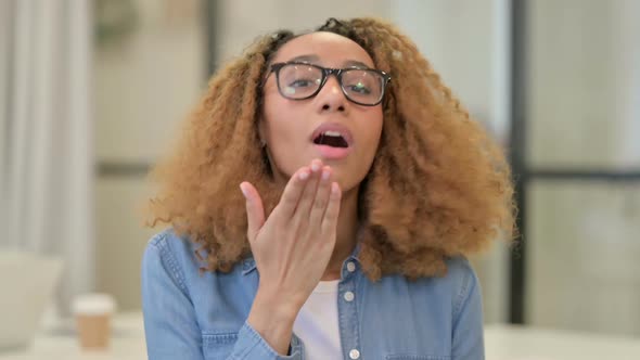 Portrait of African Woman Giving Flying Kiss By Hands