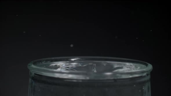 Water Droplet on a Glass of Water and Ripple Effect