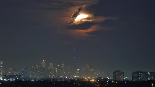 Time lapse of giant moon rising over Mississauga, Toronto, Canada, wide shot