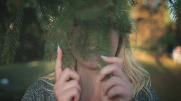 Pretty Blonde Girl Fool Around Fir Tree Branch