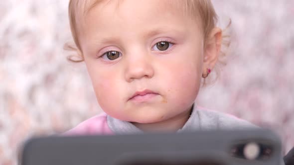 Little Girl Watching Cartoon From the Phone