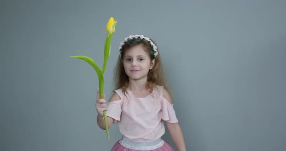 Little Girl With Bouquet Of Tulips