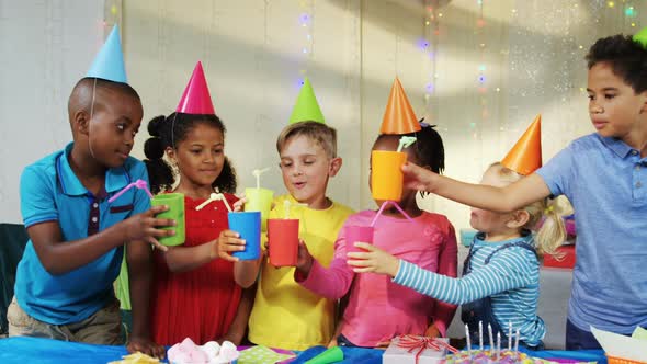 Happy children toasting drinks during birthday party 4k