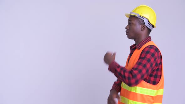 Profile View of Happy Young African Man Construction Worker Thinking