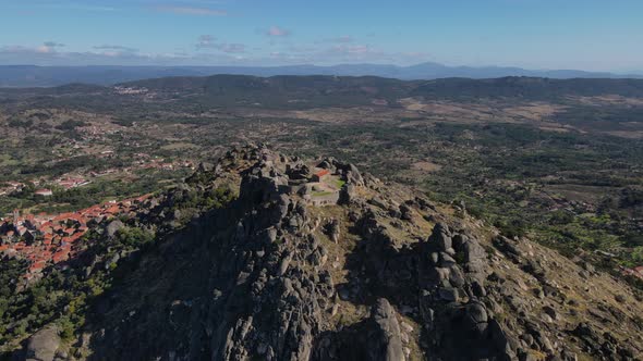 Aerial forward over Monsanto castle ruins with valley in background, Portugal