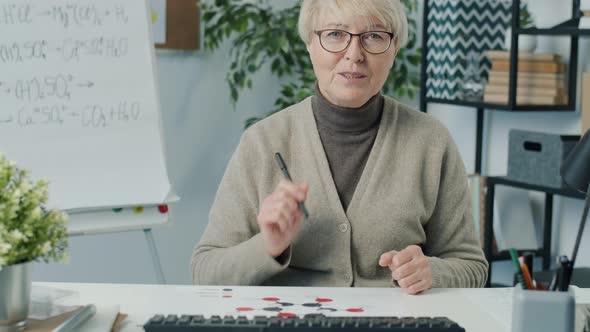 Experienced Teacher Talking and Showing Pictures During Online Lesson in Messenger During Covid19 alt