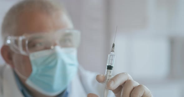 Doctor Preparing Syringe. Doctor Preparing Syringe for Injection. Female Doctor or Nurse Holding