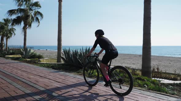 Woman cycling at sunny summer day