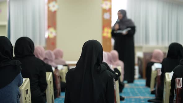 Rear view of muslim women in hijab at the mass rally listening to speaker