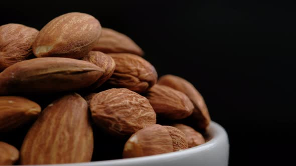 Almonds nuts rotation on black background, Close up.