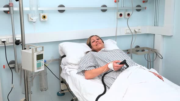 Female patient lying on a bed while looking at camera