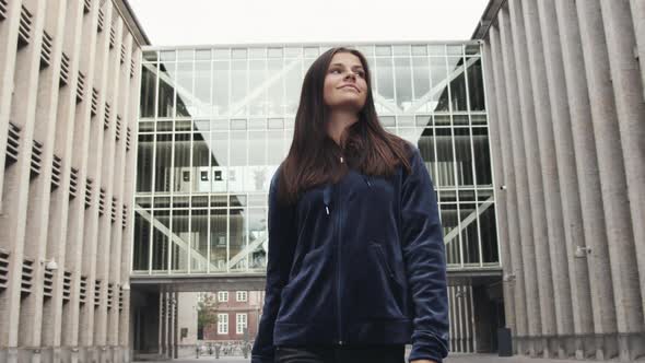 Young Teenage Model in Jacket Walking Outdoors Smiling Under Clear Bright Sky