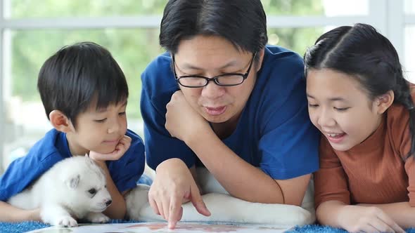 Happy Asian Family Reading Book At Home