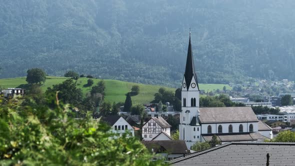 Panoramic View Liechtenstein with Houses on Green Fields in Alps Mountain Valley