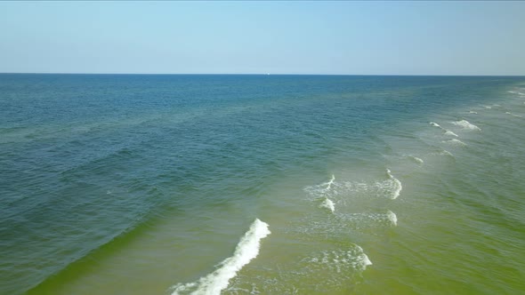 The Beautiful Scenery Of The Waves Splashing Into The Shore During Sunny Day in Osetnik Beach - Aeri