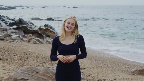 Portrait of Happy Fit Woman Standing On Beach