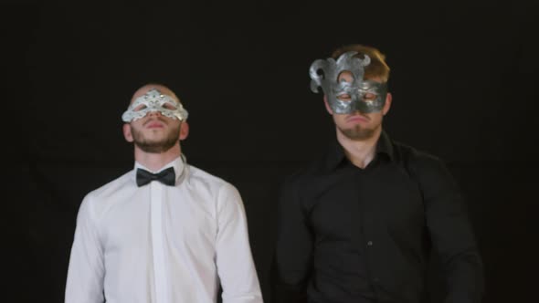 Men in Masks Posing against Black Background