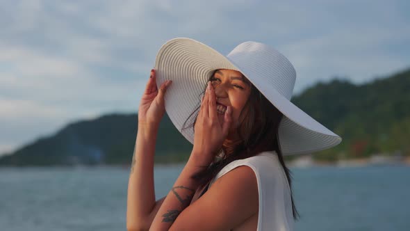 Woman In Bikini And Sunhat Smiling In Sea At Sunset