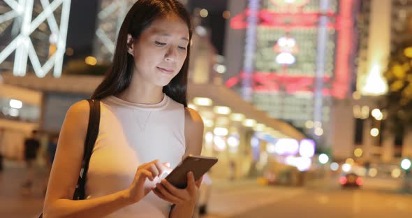 Woman using mobile phone in the city