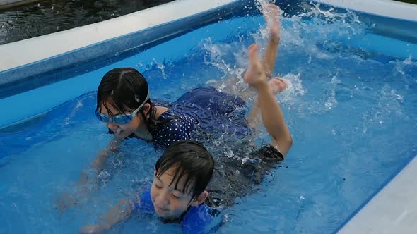 Cute Asian Children Swimming And Playing In A Pool Slow Motion