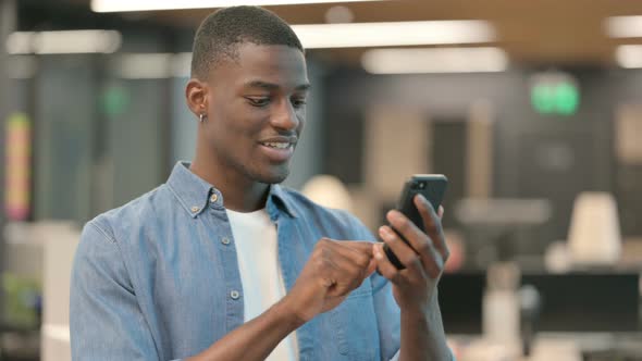 Young African American Man Using Smartphone