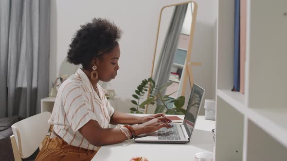 African American Laptop Working on Laptop from Home