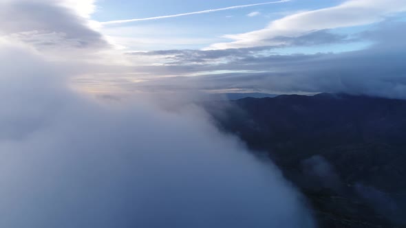 Aerial View of the Mountains in the Clouds at Sunset