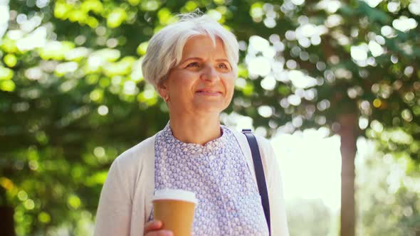 Senior Woman Walks Along Park and Drinks Coffee 8