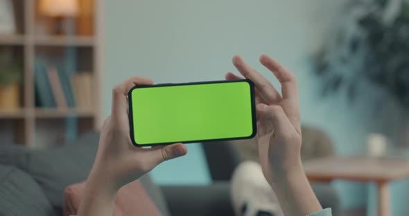 Close Up of Smartphone with Green Up Screen in Male Hands