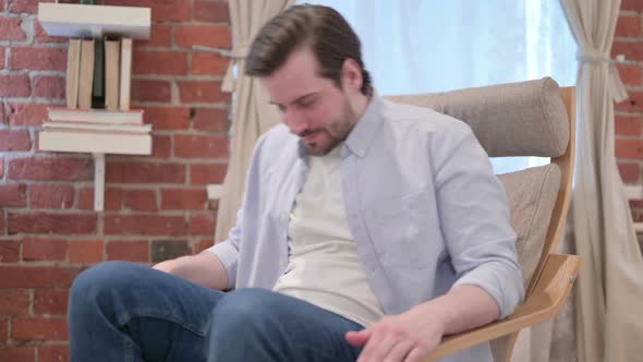 Casual Young Man Standing Up Leaving Sofa