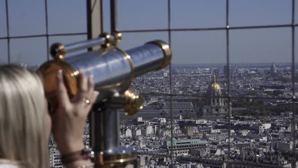 Woman Observing City with Coin Binocular