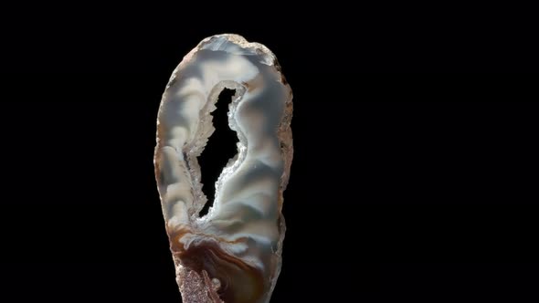 Agate with Quartz. Agate Rotates Around Its Axis on a Black Background.