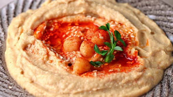 hummus with sesame and olive oil close up. Healthy vegan food. Hummus rotation. Vegetarian dish.