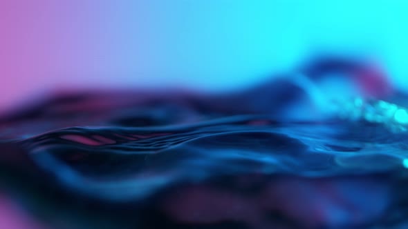 Super Slow Motion Abstract Shot of Swirling Neon Water at 1000Fps