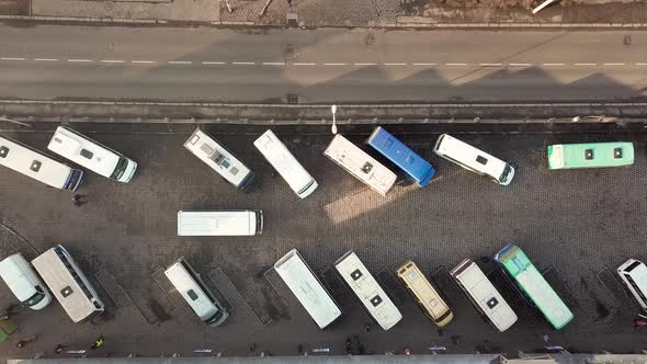 Aerial footage of many buses moving on a busy city street