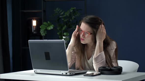 Tired Business Woman Works Late at Night in the Office