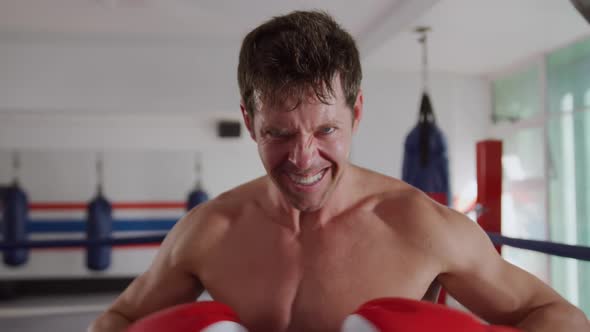 Angry caucasian man in boxing ring