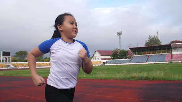Asian Little Girl Running At Stadium