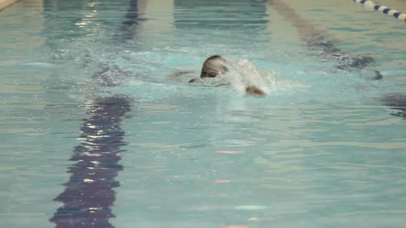 Male swimming in swimming pool in gym