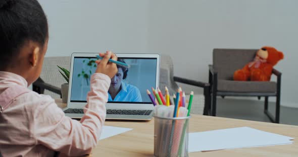 Unrecognizable Little Afro American Schoolgirl Looking at Laptop Screen at Online Teacher Male