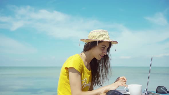 Side View Summer Freelancer Woman Working on Laptop Computer By Blue Sea During Her Travel