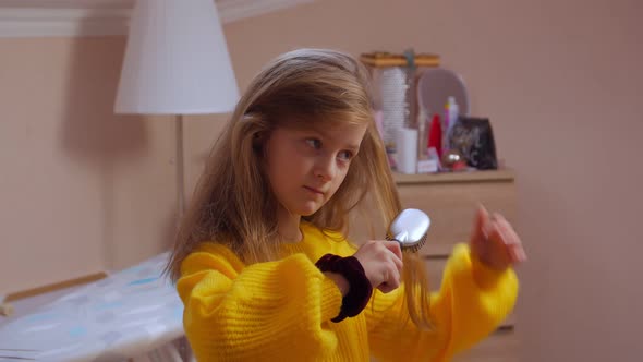 Girl Combing Her Hair Closeup