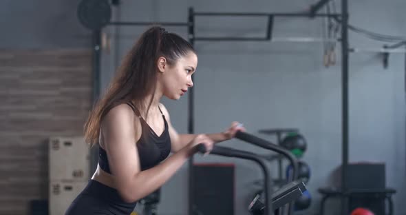 Female Gym Young Woman Trains Elliptical Bike Simulator Aerobic Exercise Endurance Training