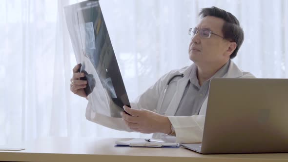 Doctor Working with Patient Health Data in the Hospital Office