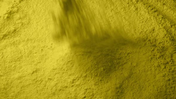 Yellow Powder Pours Into Pile