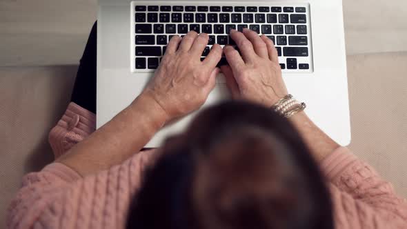 Senior Woman Hands Typing On Laptop Keyboard. Elderly Hands Typing On Notebook Keyboard.