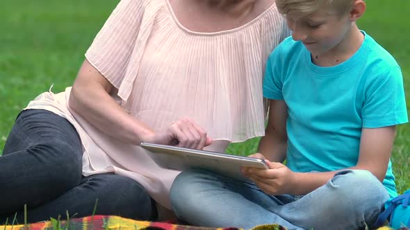 Modern Mum and Son Searching Information in Internet, Surfing Net, Technologies