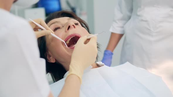 Female Patient is Having Her Oral Cavity Checked