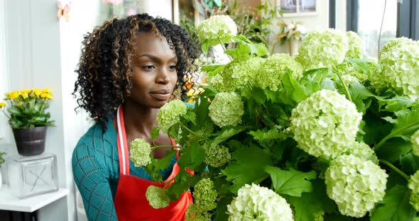 Female florist arranging flower in flower shop